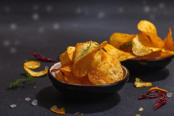 bowls-homemade-potato-chips-served-with-chili-pepper-parsley-seal-salt-black-stone-concrete-background-trendy-hard-light-dark-shadow-close-up_164638-21123